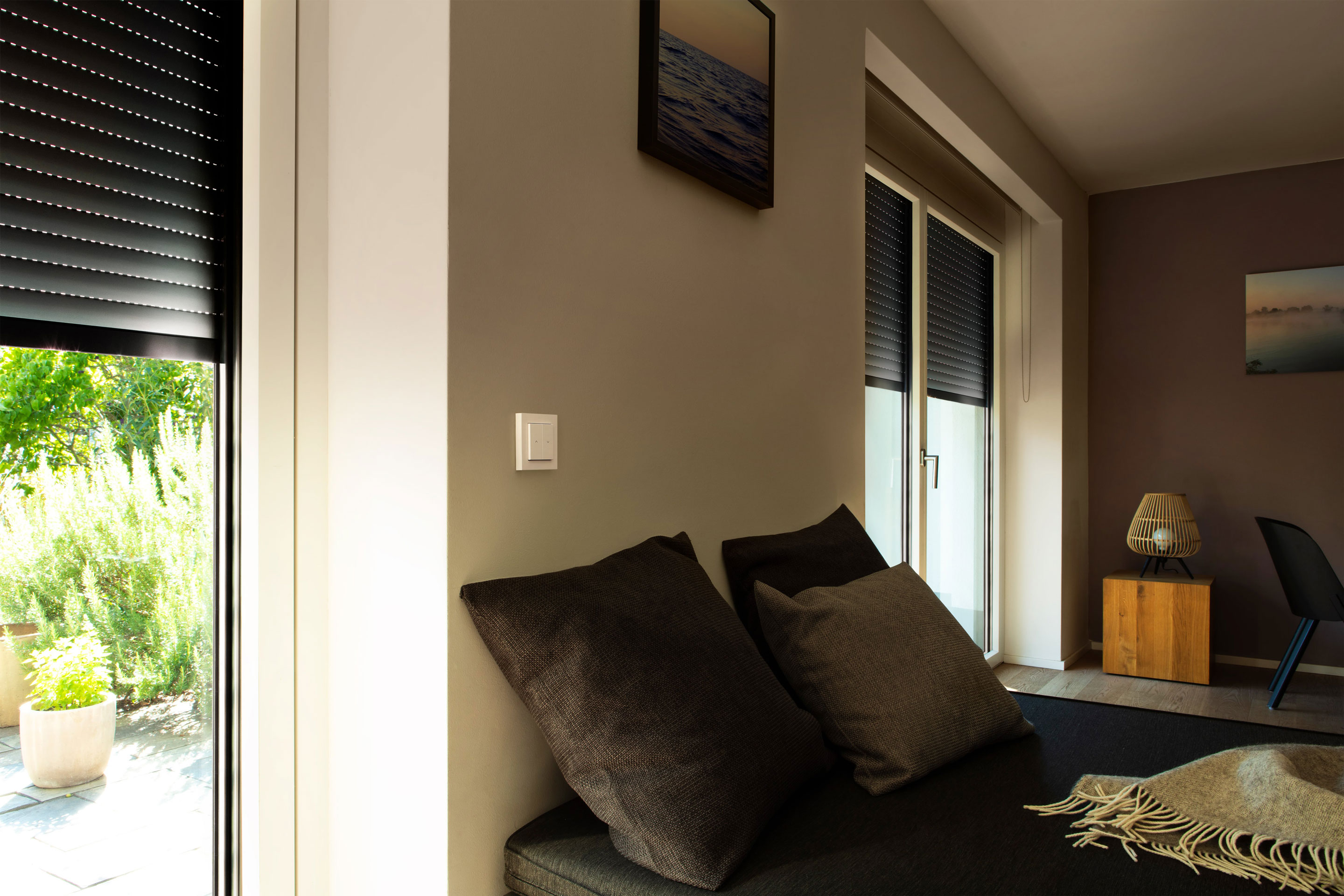 Eve Shutter Switch in a living room next to the window with half closed shutters